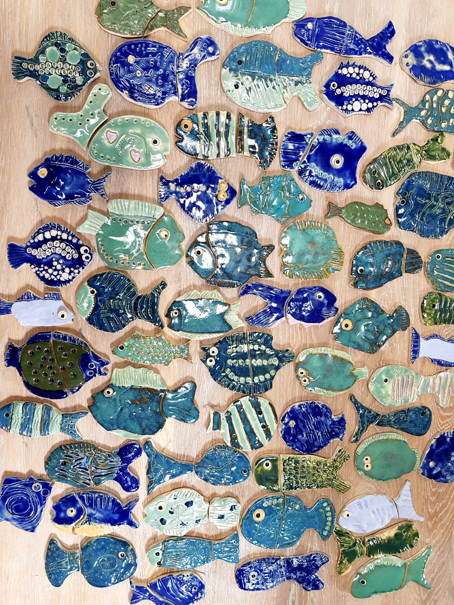Array of finished ceramic fish for the Boston Buoys mosaic